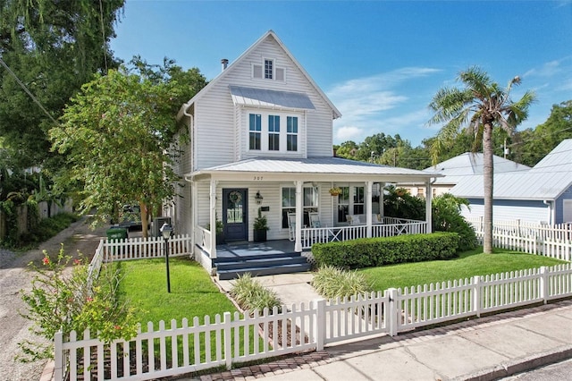 view of front facade featuring covered porch and a front lawn