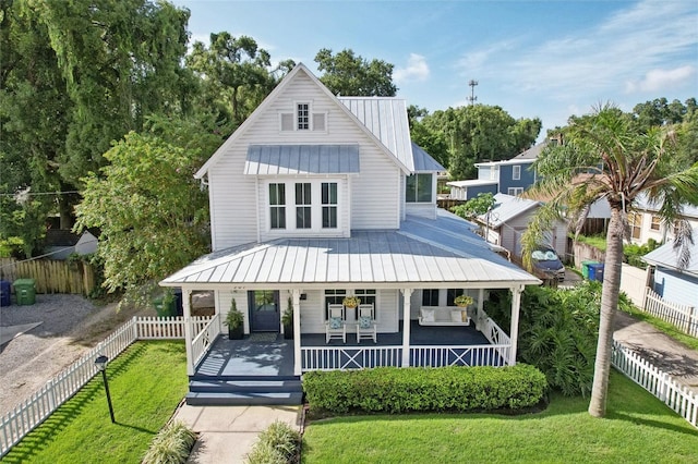 view of front of home featuring covered porch and a front yard