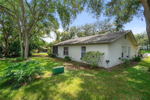 view of side of home with a lawn