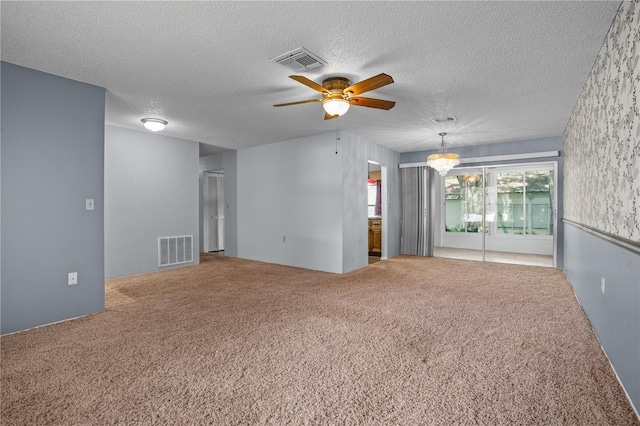 unfurnished room featuring carpet, a textured ceiling, and ceiling fan with notable chandelier