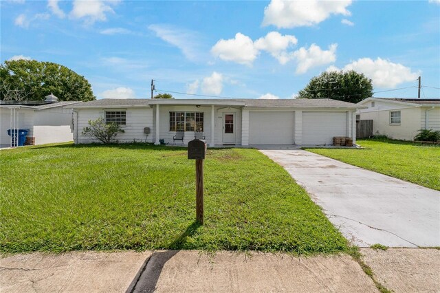 single story home with a garage and a front yard