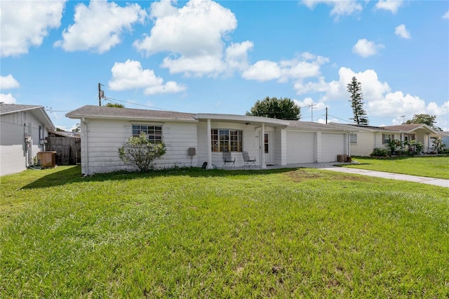 ranch-style house featuring a garage and a front lawn