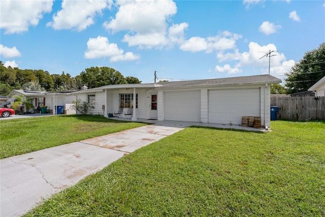 ranch-style house featuring a garage and a front lawn