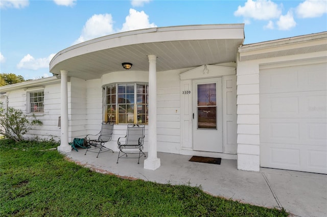 exterior space featuring covered porch and a garage