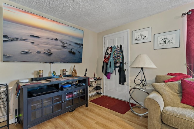 interior space featuring a textured ceiling and light hardwood / wood-style flooring