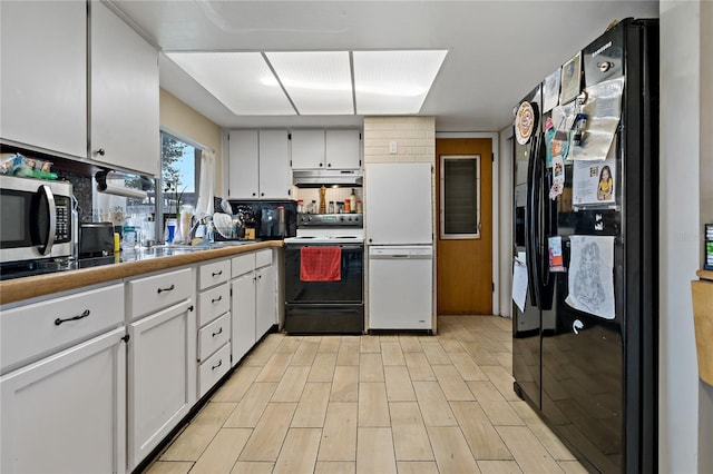 kitchen with white fridge, electric range oven, white cabinetry, and black fridge with ice dispenser