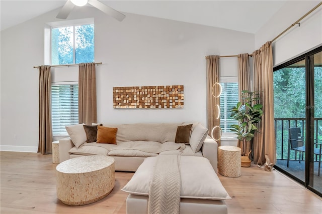 living room featuring lofted ceiling, ceiling fan, and light hardwood / wood-style flooring