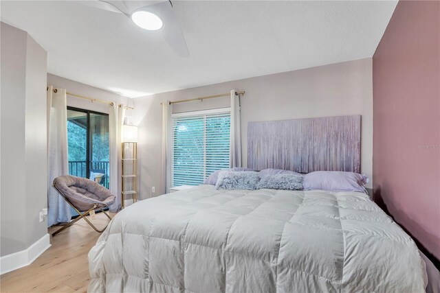 bedroom featuring light wood-type flooring and access to outside