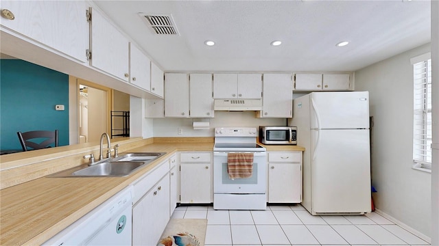 kitchen featuring white cabinetry, a healthy amount of sunlight, sink, and white appliances