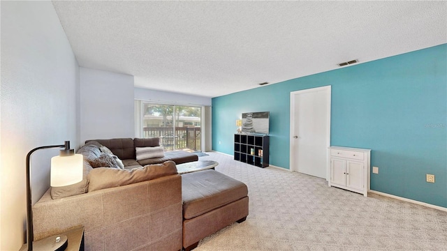 living room with a textured ceiling and light colored carpet