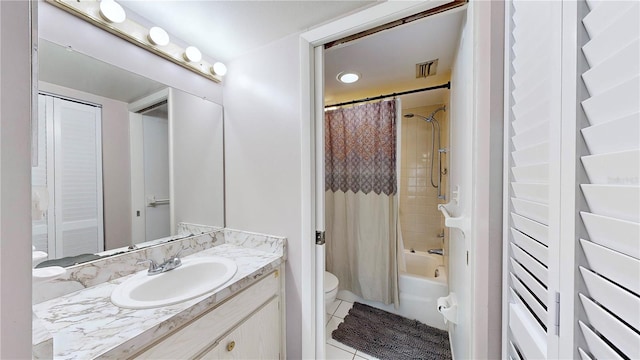 full bathroom featuring vanity, toilet, tile patterned floors, and shower / bath combo