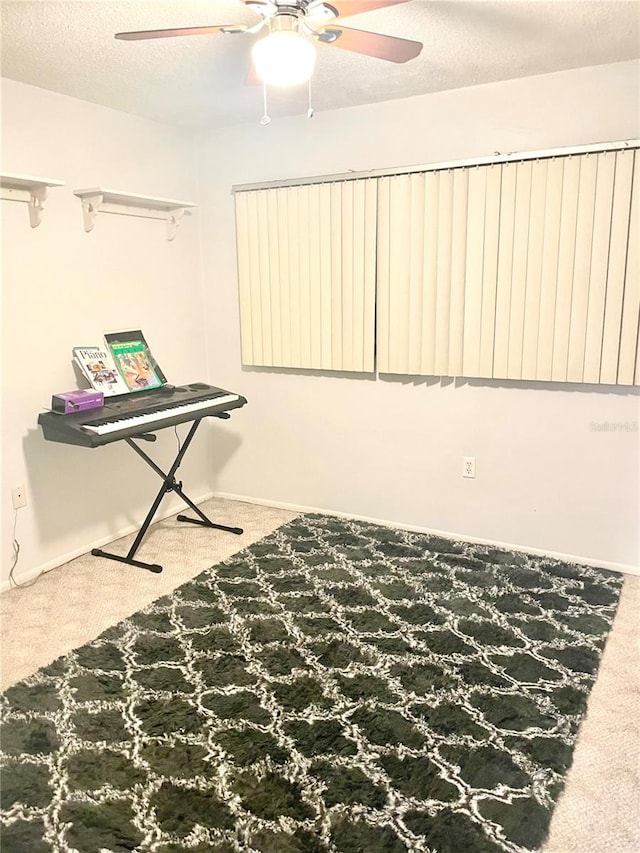 misc room with carpet floors, a textured ceiling, and ceiling fan