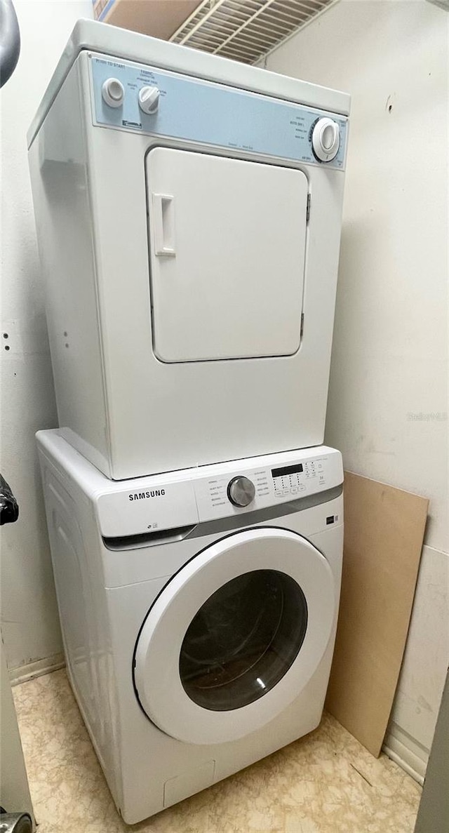 laundry area with stacked washer and dryer