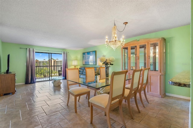 dining space featuring a chandelier and a textured ceiling