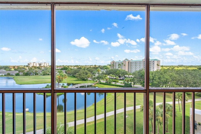 unfurnished sunroom featuring a water view