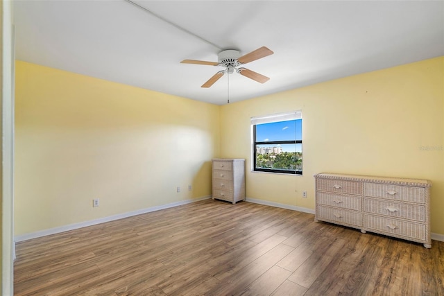 unfurnished bedroom with ceiling fan and hardwood / wood-style flooring