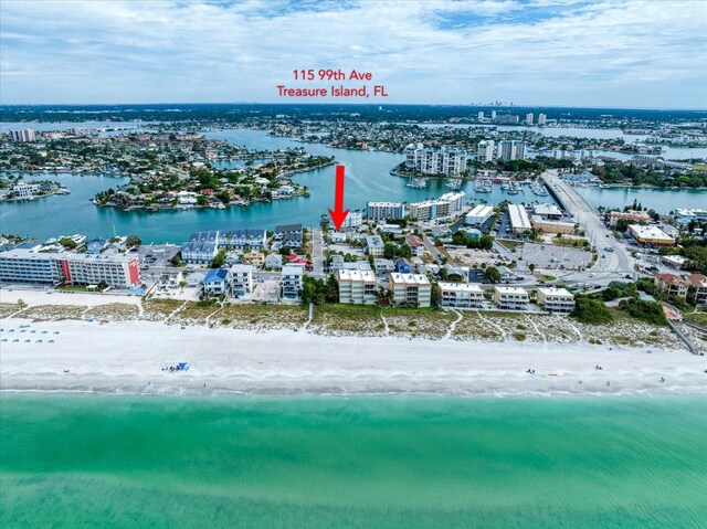 drone / aerial view featuring a beach view and a water view