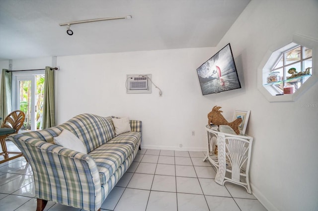 tiled living room featuring rail lighting and a wall mounted air conditioner