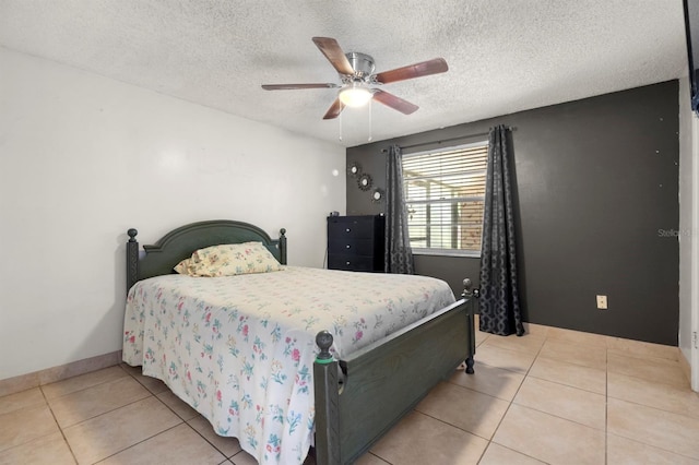 tiled bedroom featuring a textured ceiling and ceiling fan