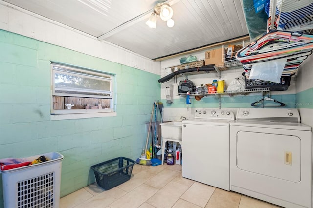 clothes washing area featuring separate washer and dryer and light tile patterned floors