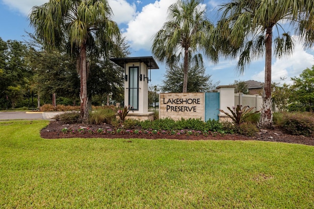 community / neighborhood sign with a yard