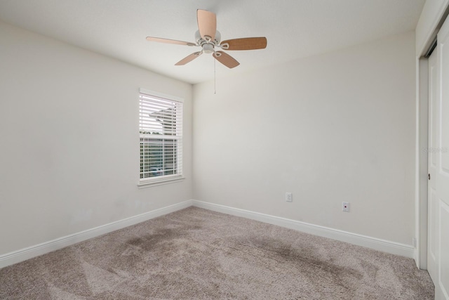 spare room featuring ceiling fan and carpet floors