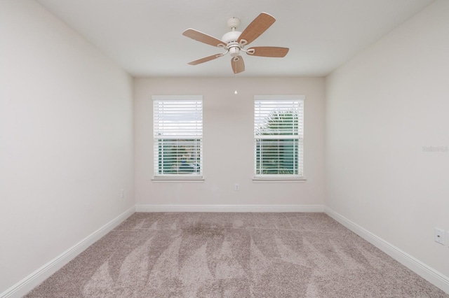 empty room with ceiling fan and light carpet