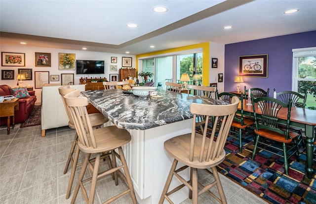 kitchen featuring a healthy amount of sunlight and a breakfast bar area