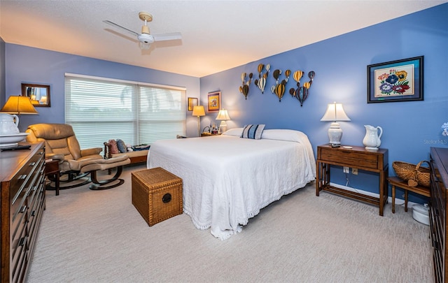 bedroom with ceiling fan and light carpet