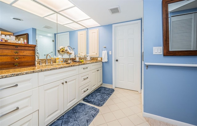 bathroom featuring an enclosed shower, vanity, and tile patterned flooring