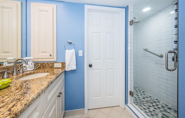 bathroom with vanity, tile patterned floors, and a shower with door