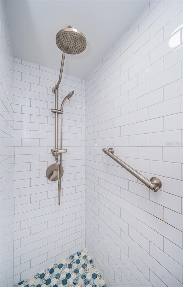 bathroom with tiled shower