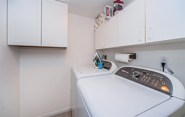 laundry room with cabinets and washing machine and clothes dryer