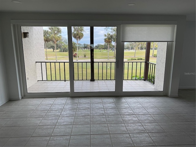 doorway to outside with tile patterned floors