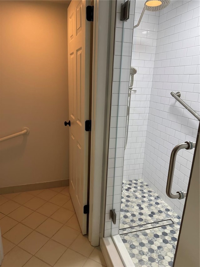 bathroom with tile patterned flooring and a shower with door