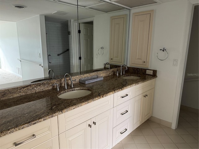 bathroom featuring vanity, tile patterned flooring, and a shower with door