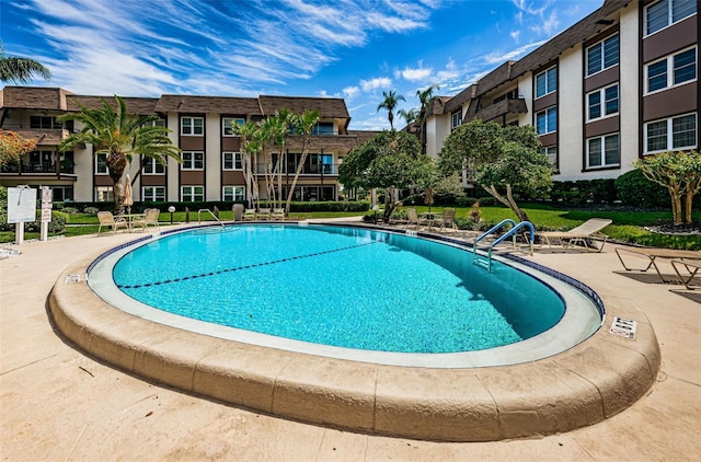 view of swimming pool with a patio