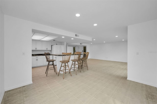3021 Countryside Blvd Unit 28A, Clearwater, FL 33761 - kitchen featuring a kitchen bar and white cabinets