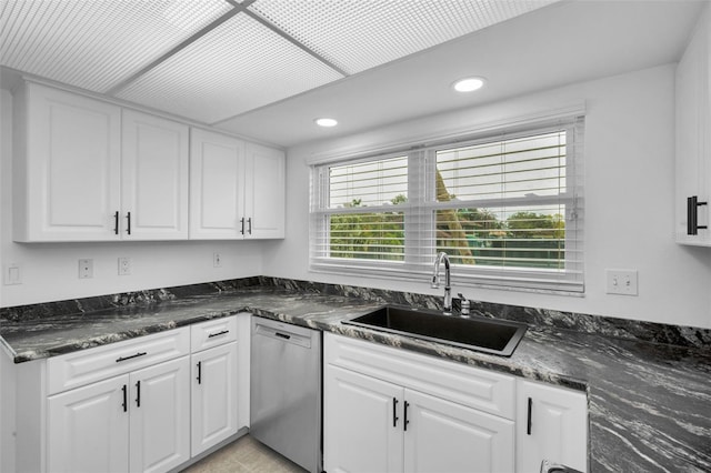 3021 Countryside Blvd Unit 28A, Clearwater, FL 33761 - kitchen featuring stainless steel dishwasher, white cabinets, dark stone counters, and sink