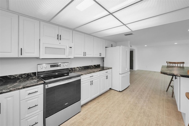 3021 Countryside Blvd Unit 28A, Clearwater, FL 33761 - kitchen featuring white cabinetry and white appliances