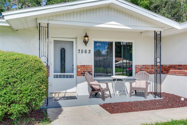 doorway to property featuring covered porch