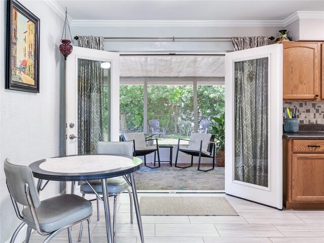 dining area with light hardwood / wood-style floors and ornamental molding