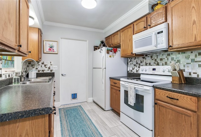 kitchen featuring crown molding, white appliances, sink, and decorative backsplash