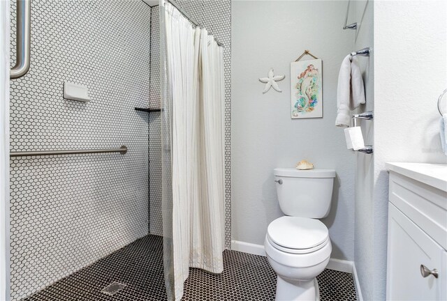 bathroom with tile patterned floors, toilet, curtained shower, and vanity