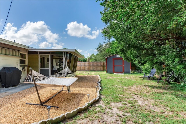 view of yard with a storage unit and a sunroom