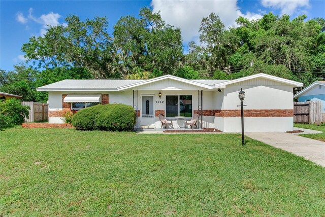 ranch-style house with a front lawn and a porch