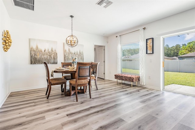 dining area featuring a chandelier and light hardwood / wood-style floors