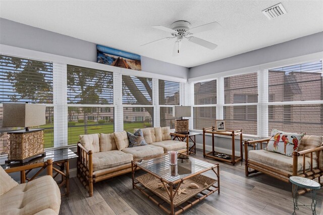 sunroom / solarium featuring ceiling fan and plenty of natural light