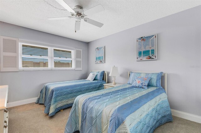 bedroom with a textured ceiling, carpet, and ceiling fan