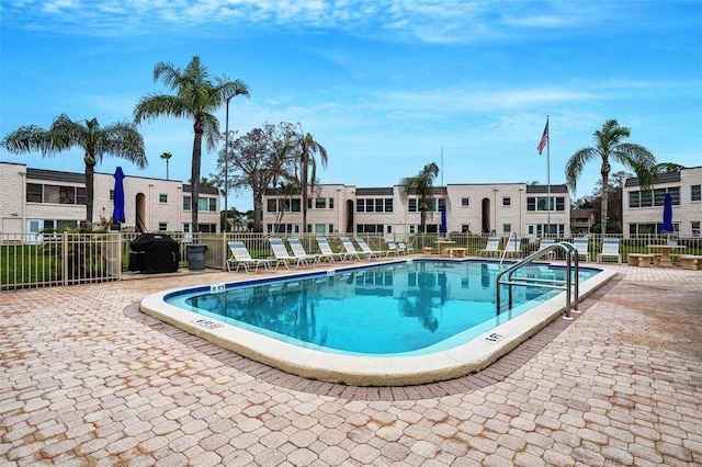 view of pool featuring grilling area and a patio